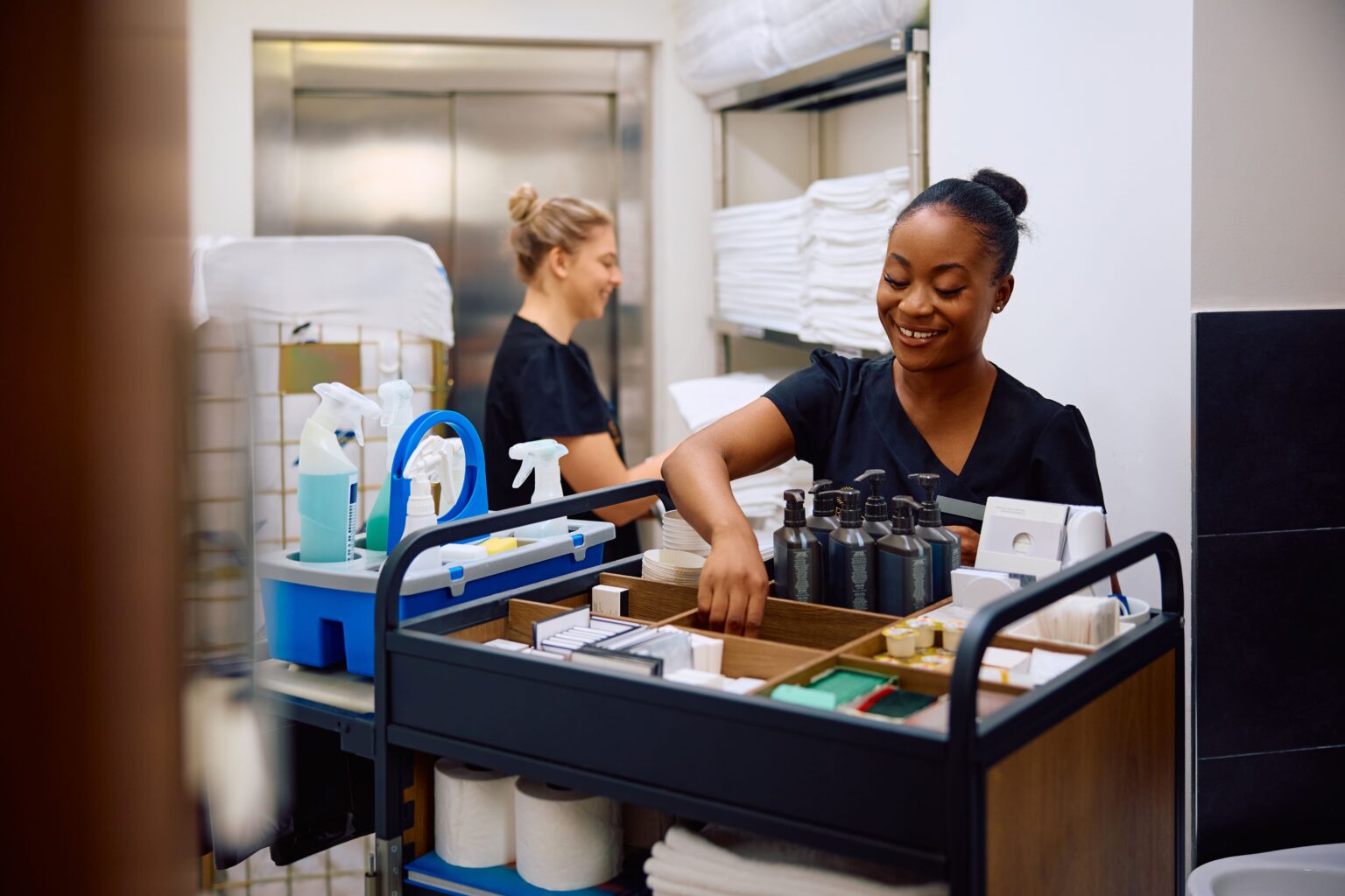 happy-black-chambermaid-restocking-housekeeping-tr-2024-12-13-18-21-01-utc